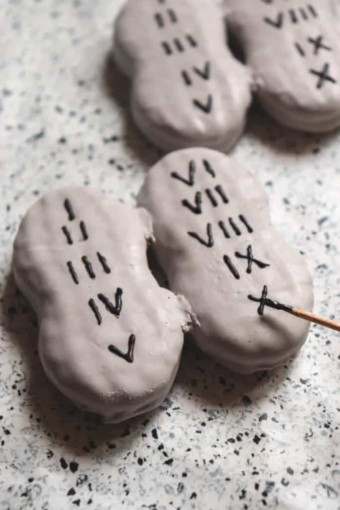 nutter butter cookies dipped in mixed chocolate with roman numerals to look like the ten commandments